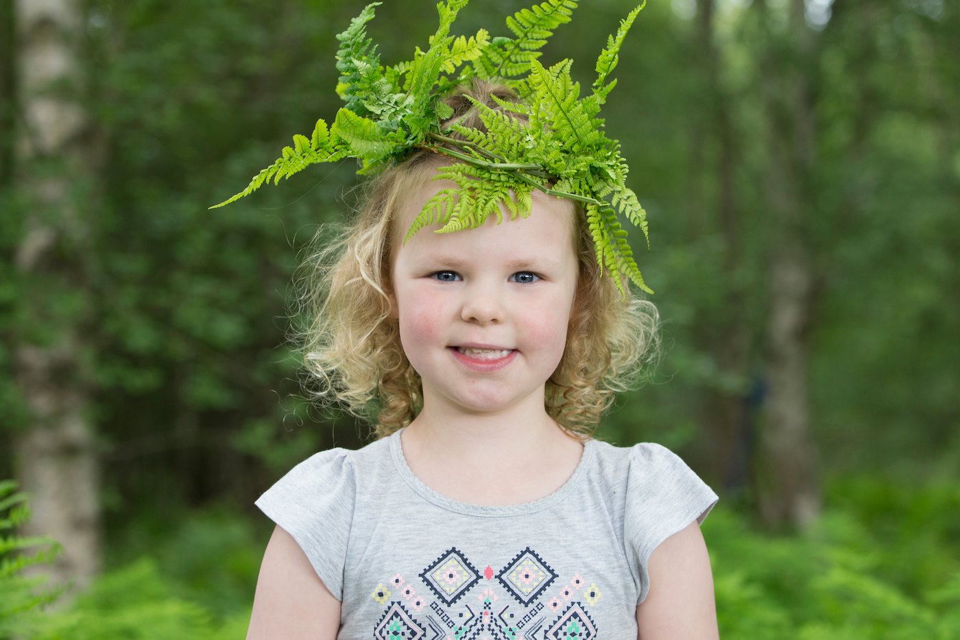 Young girl playing in woodland as part of "Mucky Boots" forest Kindergarten group, Aberdeen, Scotland.
(MR available)