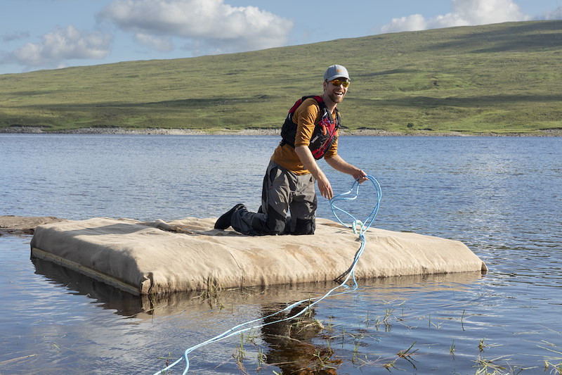 Andrew Spence afloat on black-throated diver nesting platform, Overscaig, Sutherland